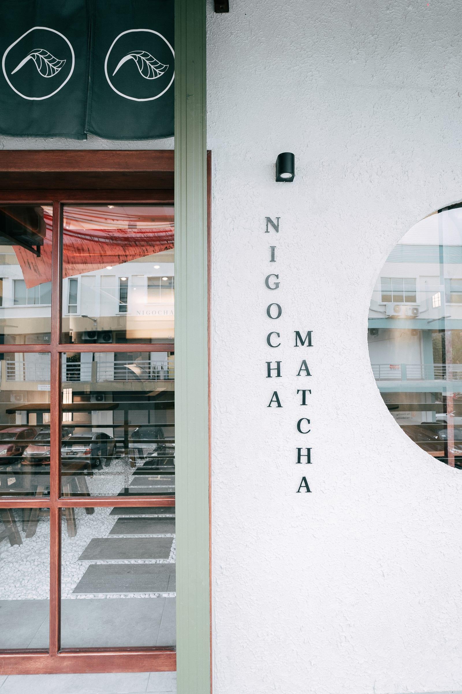 The entrance: the noren with leaf circles and NIGOCHA MATCHA lettered down the wall